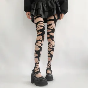Gothic punk distressed black fishnet tights, edgy alt pantyhose for bold street fashion looks.