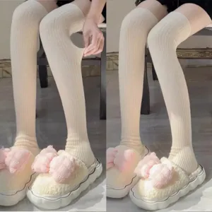 Close-up detail of ribbed knit over-the-knee long socks showing stretchy texture and comfortable fit.
