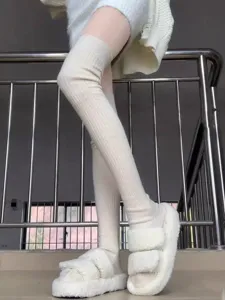 Ribbed over-the-knee knit socks detail shot, soft warm long tube stockings for women winter.