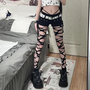 Gothic punk black ripped fishnet tights, edgy cutout pantyhose for alternative style fashion.