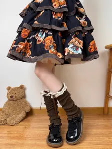 Brown knit leg warmers with lace trim and bows worn with Lolita bear print skirt detail.