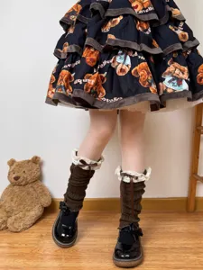 Close-up of sweet lolita leg warmers featuring white lace trim and cute brown ribbon bows.