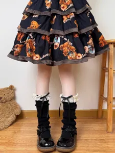 Detailed shot of black knit leg warmers with lace ruffles and cute bows for sweet style.