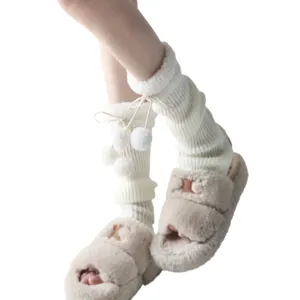 Japanese style winter knitted leg warmers with pompoms paired with fuzzy H cut-out slippers.