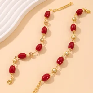Chic bracciale placcato oro con perle in finta agata rossa e bellissime sfere in filigrana.
