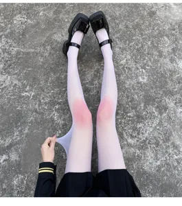 Detail view of ultra-thin gradient blush white pantyhose showing great elasticity.