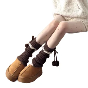 Womens knit leg warmers with cute pom pom bows and winter fleece boots for cute style.
