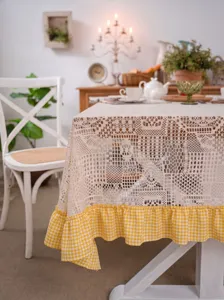 Vintage crochet lace tablecloth with yellow gingham ruffle border for farmhouse dining.