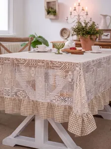 Detailed shot of vintage lace tablecloth with checkered ruffle, elegant pastoral table decor.