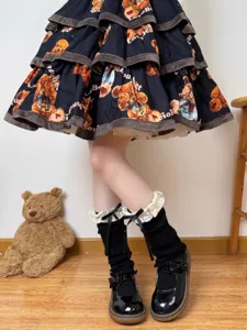 Sweet Lolita black leg warmers with lace ruffles and cute bow accents, detailed knit slouch socks view.