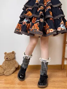 Detailed shot of Japanese sweet lolita grey leg warmers with lace trim and black shoes.