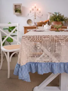 Vintage crochet lace tablecloth with blue and white check ruffle for table decor.