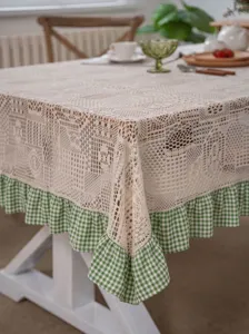 Elegant vintage crochet tablecloth featuring a fresh green and white checkered ruffle hem.