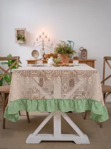Vintage crochet lace tablecloth with green checkered ruffle edge for dining table decor.