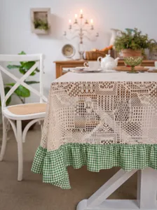Exquisite beige crochet lace tablecloth featuring a charming green and white gingham ruffled hem.