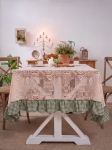Vintage lace crochet tablecloth with green gingham ruffle country style dining table cover.