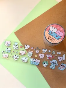 Cute cartoon bear washi tape and PET sticker roll detail shot for journal decoration and crafts.