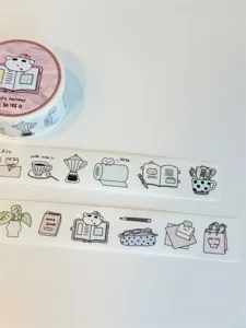 Detailed view of cute bear and stationery decorative washi tape roll and unrolled display.