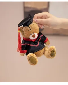 Close-up of a cute plush graduation bear wearing a mortarboard cap and academic gown.