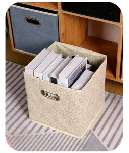 Fabric storage box detail showing beige leaf pattern, durable material and metal handle.