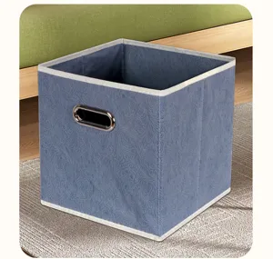 Foldable fabric storage box with embossed floral pattern and metal handle for home wardrobe.