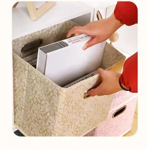 Foldable fabric storage box with metal handle, ideal for wardrobe clothes and closet organization.