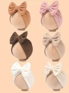 Detailed view of cute knitted baby bow headbands showcasing soft texture and multiple color options.
