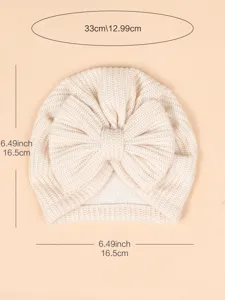 Detailed view of the newborn knitted turban hat featuring a cute big bow and clear size guide.