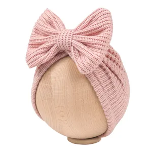 Newborn pink knitted bow turban hat detail, cute infant beanie with large bow accent.