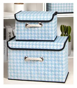 Blue and white houndstooth fabric storage box with lid, rope handles and black trim.