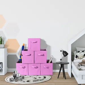 Pink foldable fabric storage box set displayed in a cozy children room scene detail view.