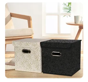 Close-up detail of foldable fabric storage boxes featuring floral patterns and metal handles.