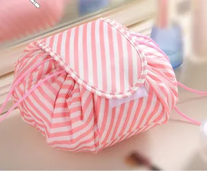 Pink striped drawstring makeup bag detail closeup, waterproof cosmetic pouch for travel use.