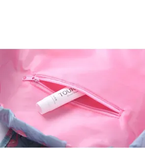 Detail view of the waterproof travel cosmetic bag showing the interior zipper pocket and lining.