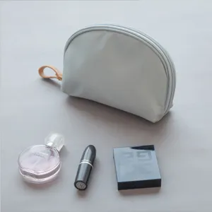 Portable light blue cosmetic bag, stylish half-round makeup pouch with zipper for travel use.