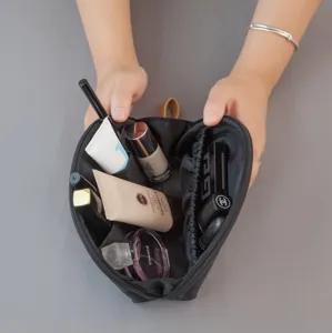 Compact travel makeup pouch with compartments, portable mini cosmetic bag for women.