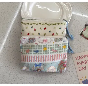Cute cartoon canvas zipper pouch for women, portable cosmetic and lipstick storage bag.