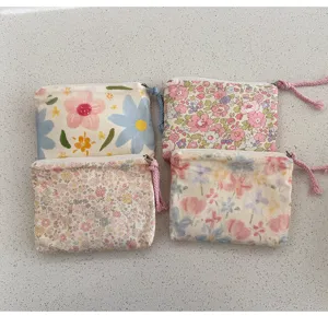 Detailed view of cute floral print mini canvas zipper pouches for daily coin and lipstick use.