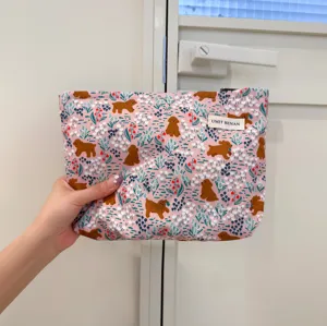 Cute pink cosmetic bag with cute dog floral print, portable travel toiletry pouch for women.