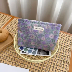 Vista dettagliata della borsa cosmetica in tessuto floreale con etichetta e grande spazio.