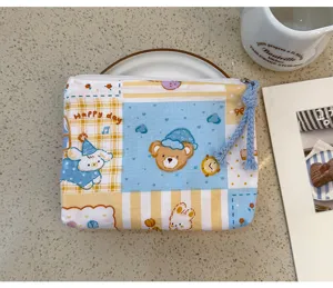 Cute cartoon canvas zipper pouch detail, featuring adorable bear and plaid design for daily use.