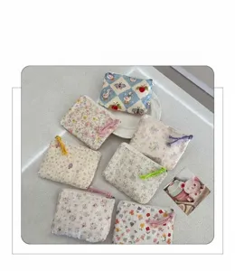 Floral print cosmetic pouch detail shot, cute cotton makeup bag with zipper closure.