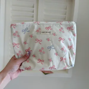Cute bow print cosmetic bag, portable makeup pouch, large capacity travel storage organizer.
