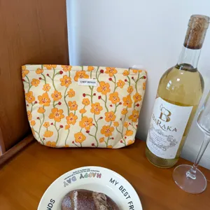 Floral print cotton cosmetic bag, portable travel storage pouch with zip closure and chic label.