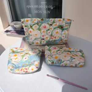 Detailed view of floral canvas cosmetic bag, oil painting style makeup pouch for travel.