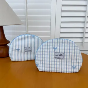 Blue striped plaid bow cosmetic bag, portable fabric makeup pouch for daily travel use.