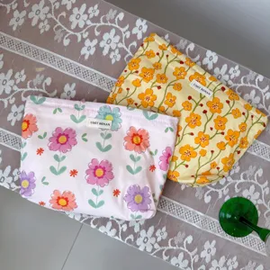 Floral cotton cosmetic bag with zipper closure and cute flower prints for daily makeup storage.