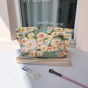 Detailed shot of large capacity oil painting floral cosmetic makeup bag for travel and daily use.