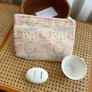 Close-up detail of the pastoral grid rabbit cosmetic bag, showing fabric texture and cute pattern.