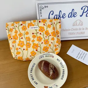 Floral cotton makeup pouch featuring orange blossom print for daily cosmetic storage.